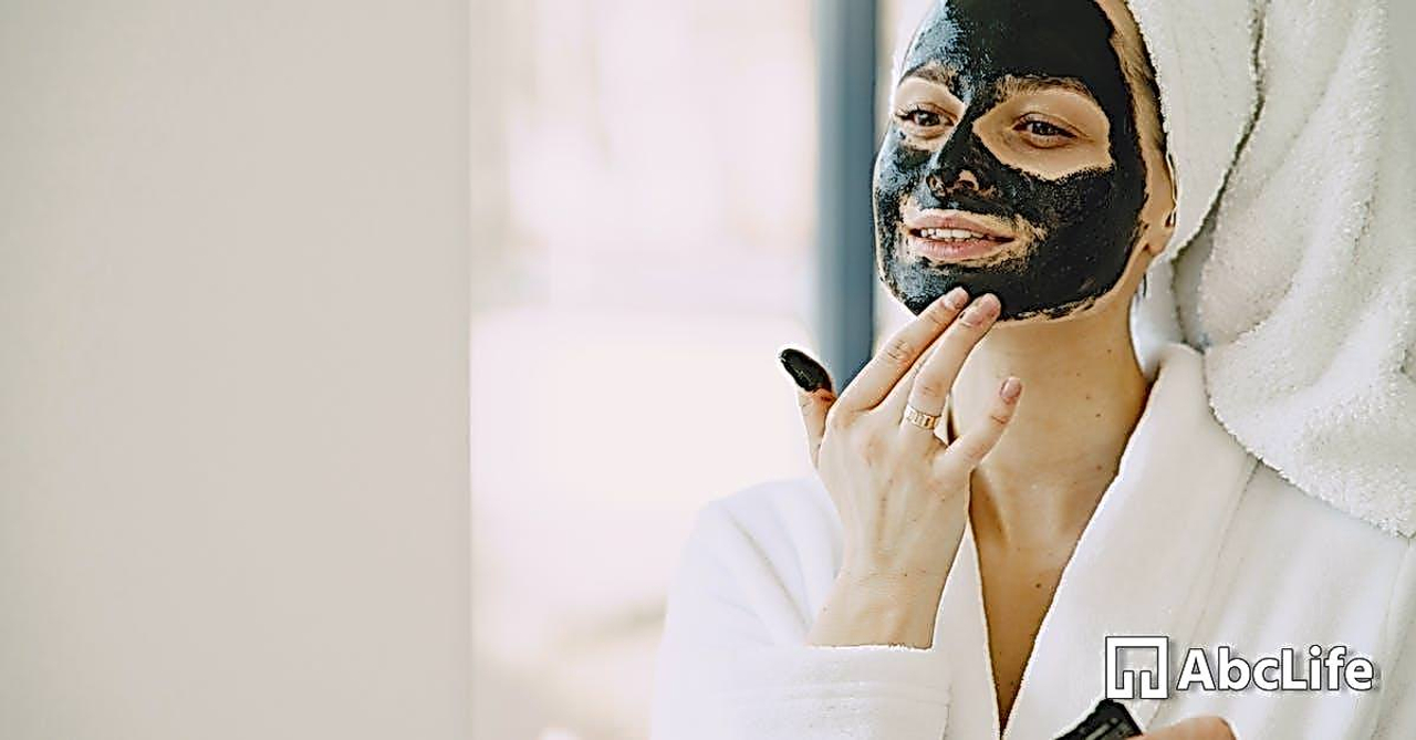 Photo of Woman Applying Clay Mask on Her Face