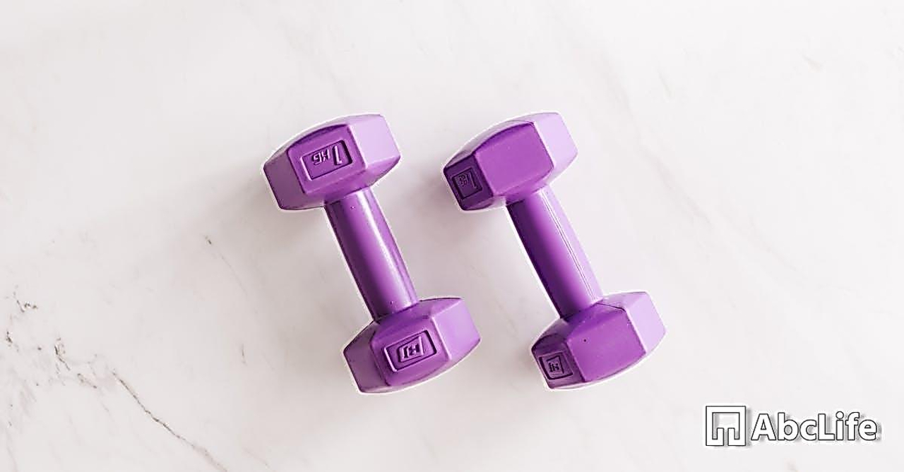 Purple all cast dumbbells on marble surface