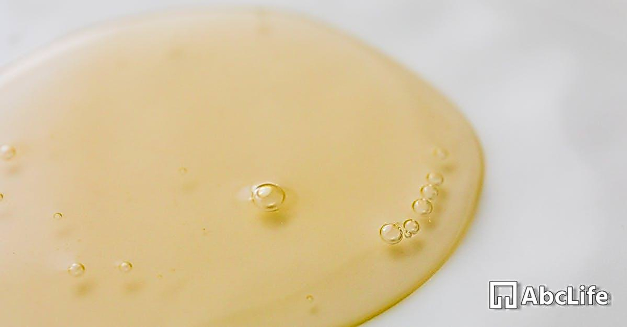 Transparent yellowish liquid on white surface