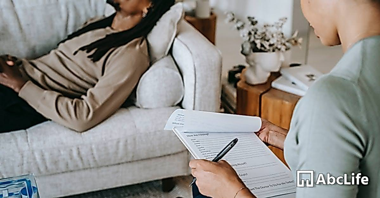 Crop black woman with questionnaire interacting with boyfriend on couch